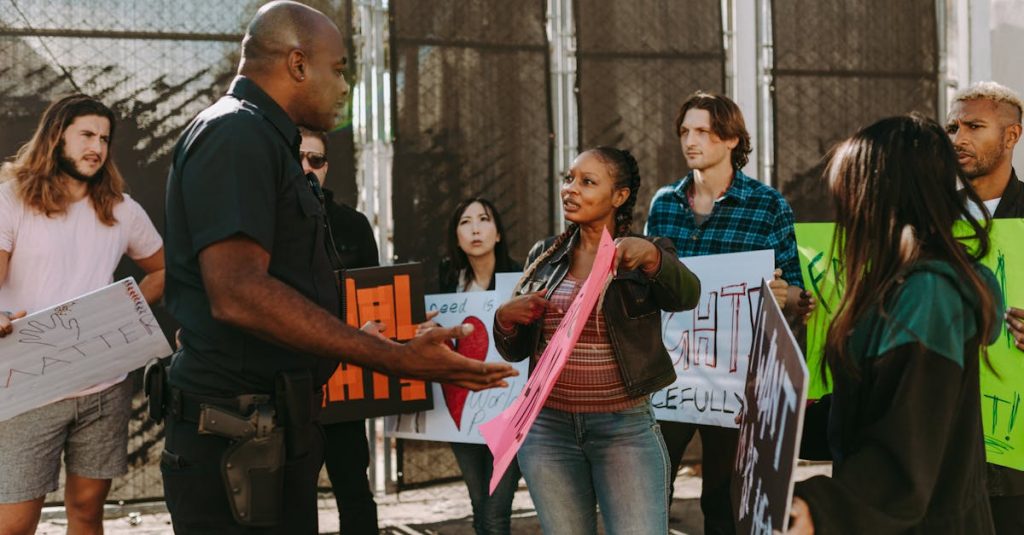 a-diverse-group-of-people-engaged-in-a-peaceful-protest-outdoors-discussing-with-a-police-officer-1